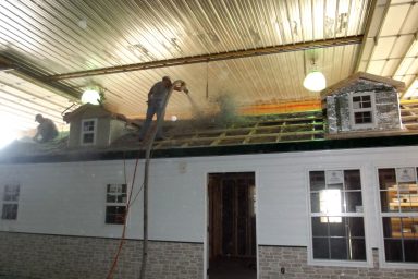 16x40 cabin spraying insulation on roof